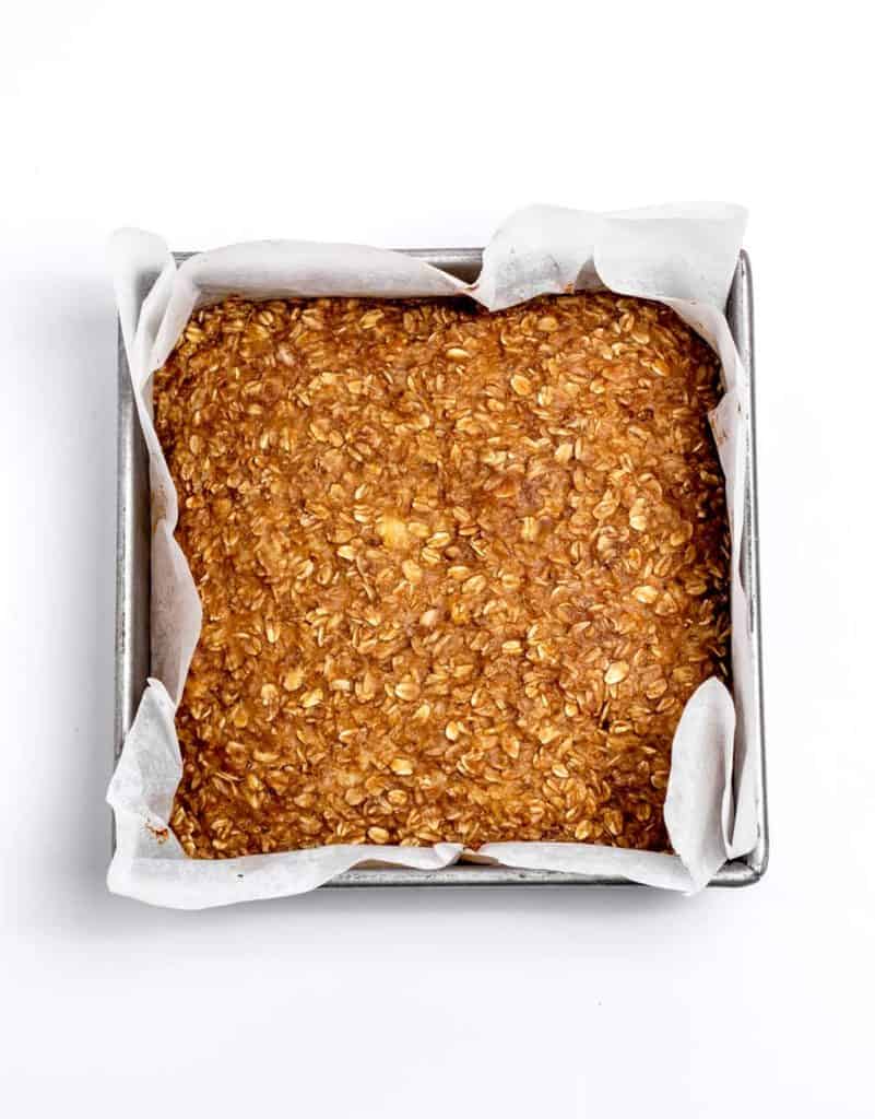 Baked banana oat mixture in a square baking pan.