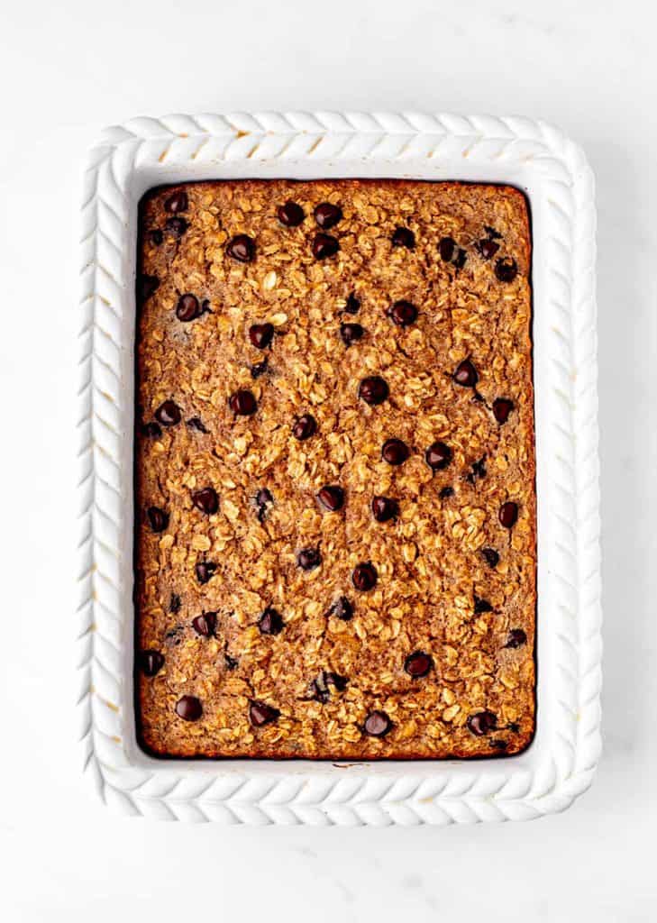 The baked chocolate chip oatmeal in a white baking dish.