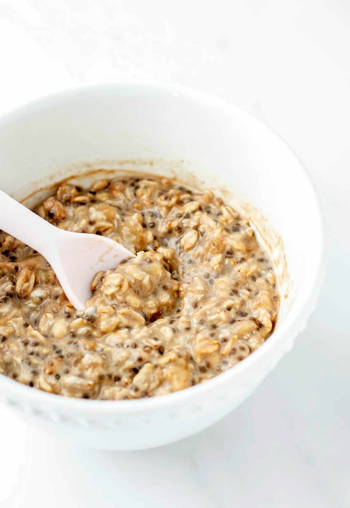 An up close image of a spoon scooping up some baby overnight oats.