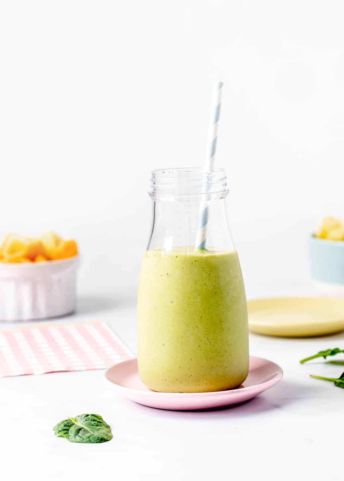 A milk bottle filled with green smoothie without yogurt or banana.