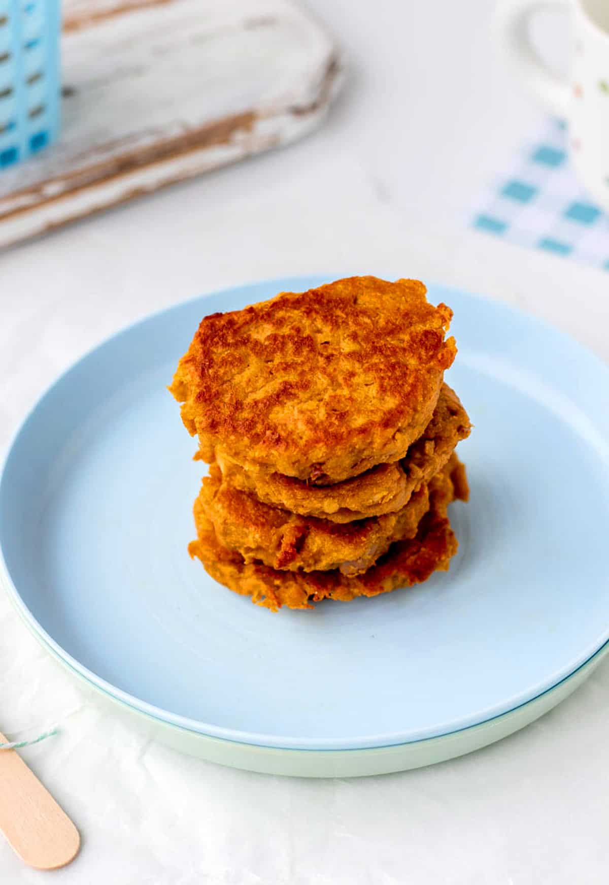 A stack of sweet potato patties on a blue plate.