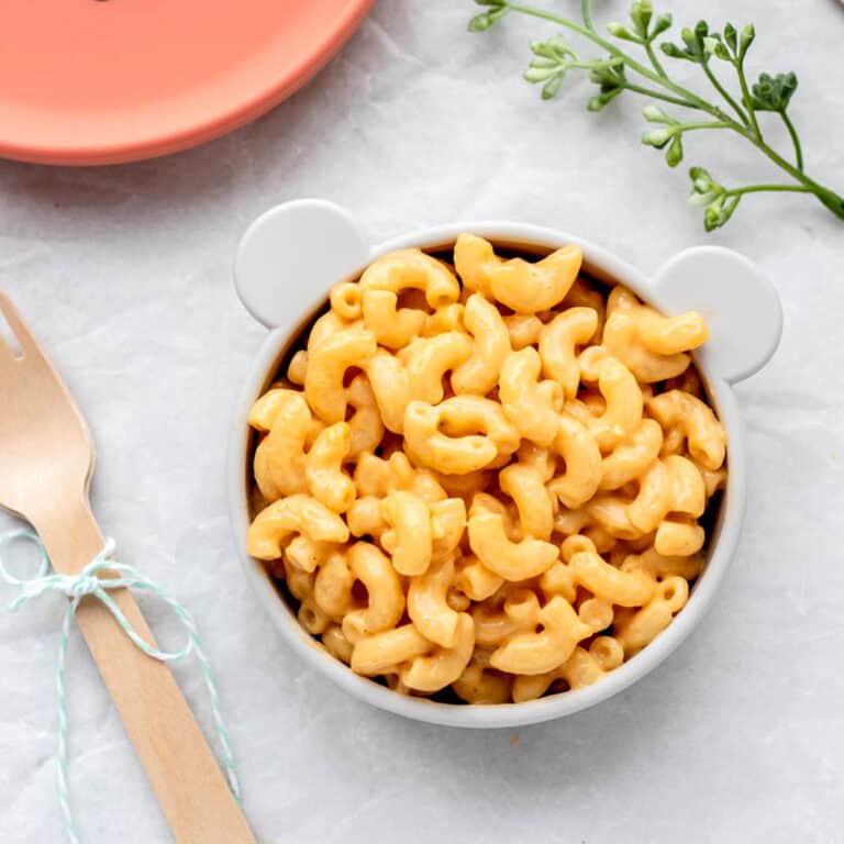 5 ingredient mac and cheese in a bowl next to forks and a plate.