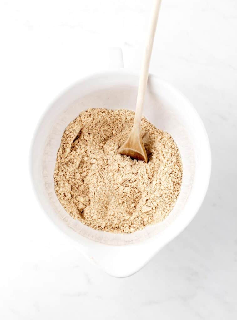 The dry ingredients for banana bread combined in a white bowl.