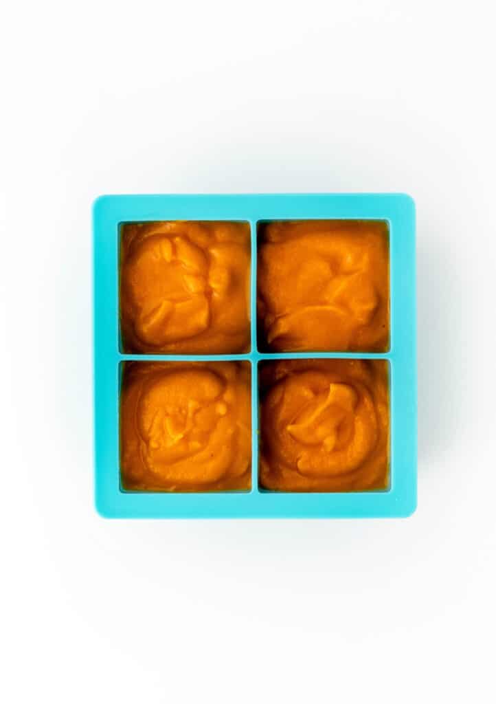 Roasted carrot pasta sauce in a silicone ice cube tray.