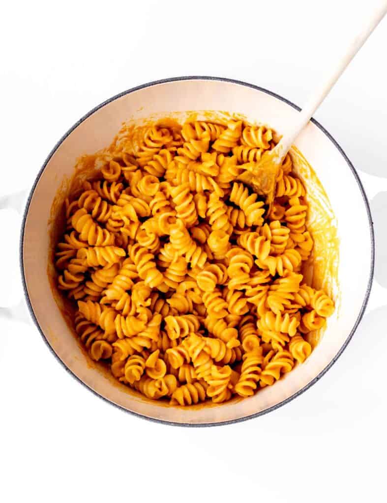 The roasted carrot pasta sauce mixed in with the cooked noodles.