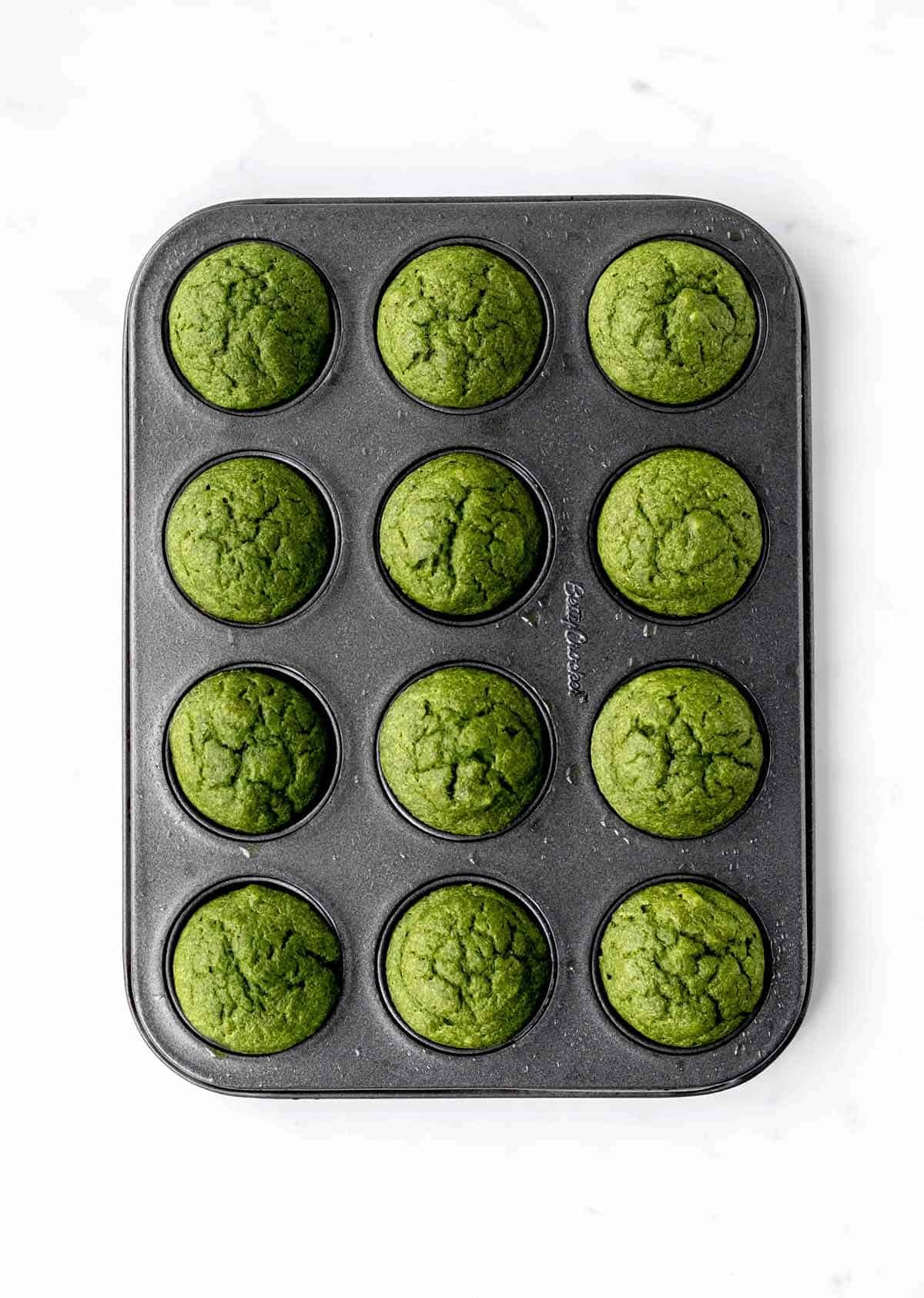 The baked green monster muffins in a mini muffin tin.