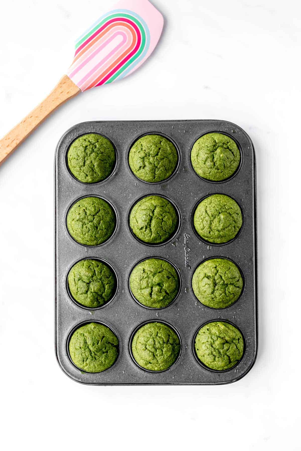 The baked green monster muffins in a mini muffin tin.