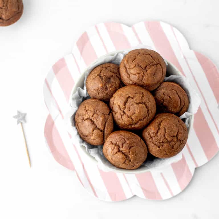 A close up image of mini date muffins in a small bowl.