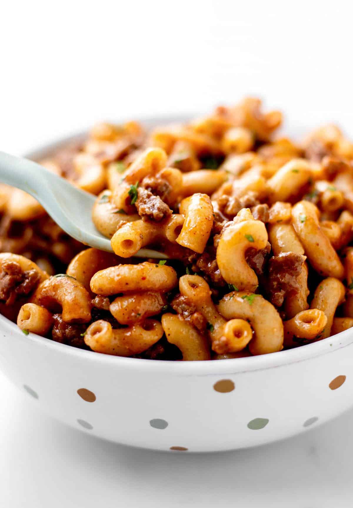 A fork digging into a bowl of homemade hamburger helper.