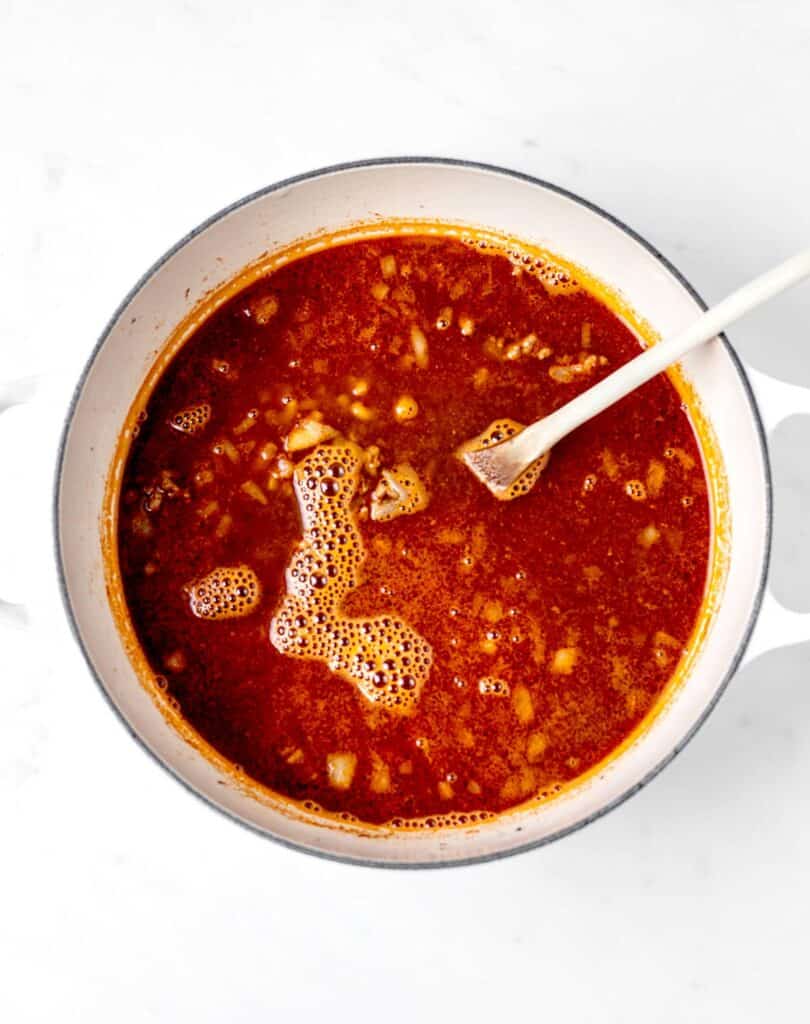 Broth added to the beef and onions in a large pot.