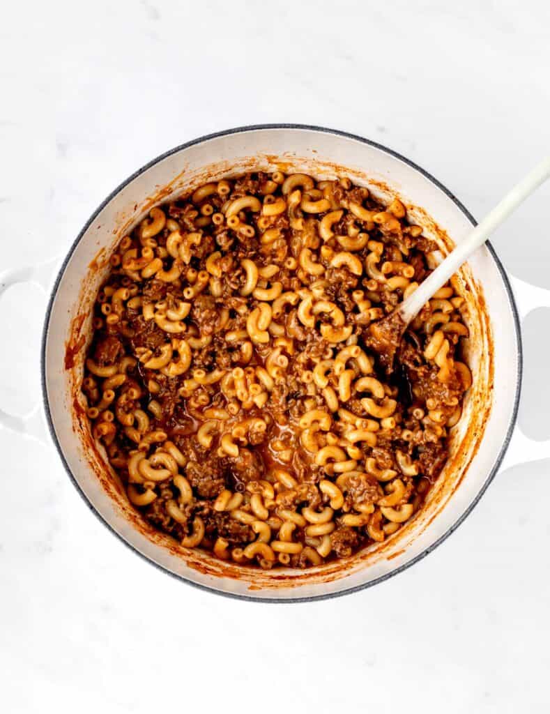 One pot homemade hamburger helper in a large pot with a wooden spoon.