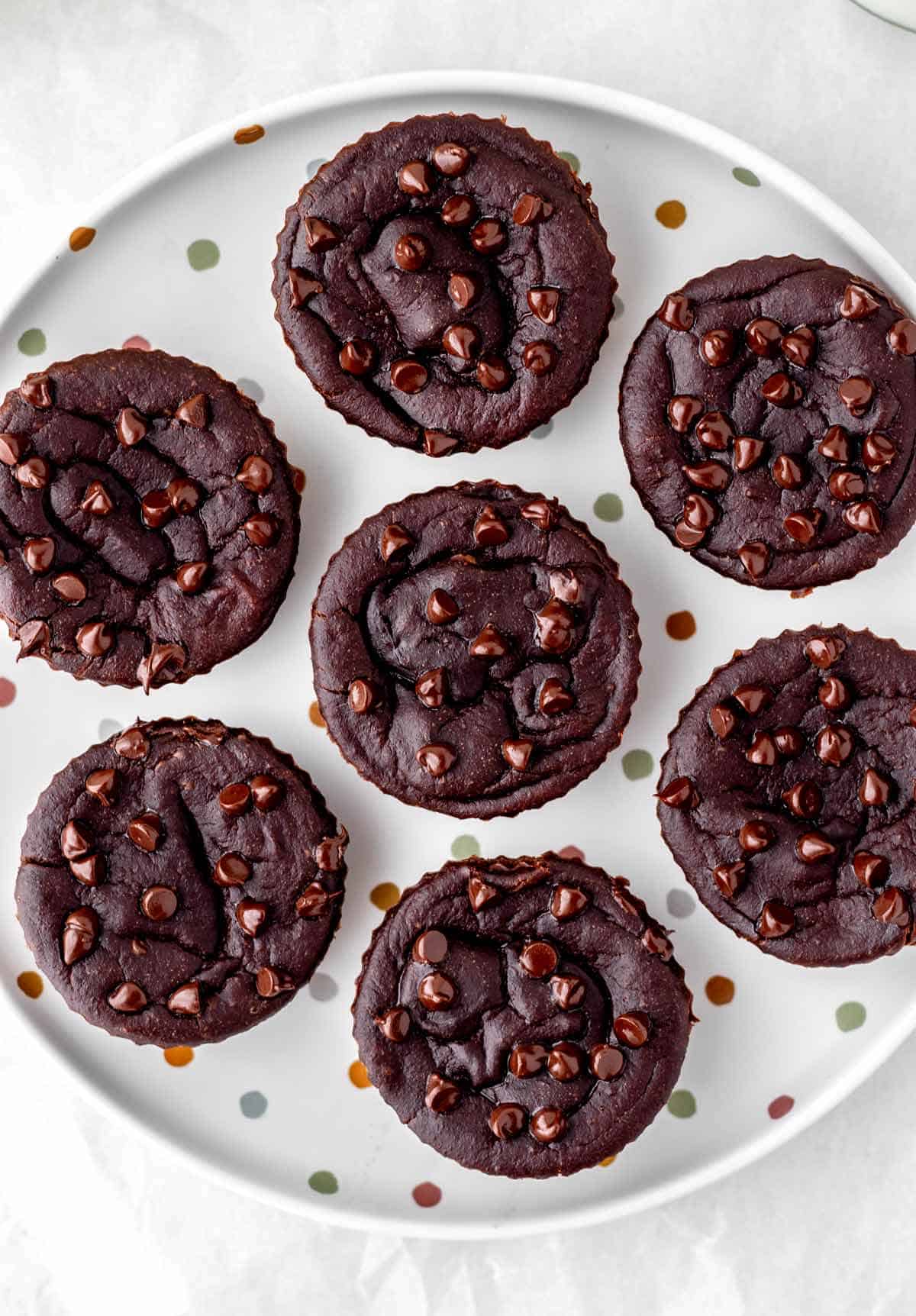 A polka dot plate with 3 ingredient banana brownies topped with chocolate chips.