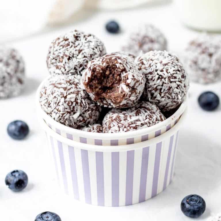 A purple striped container with blueberry bliss balls.