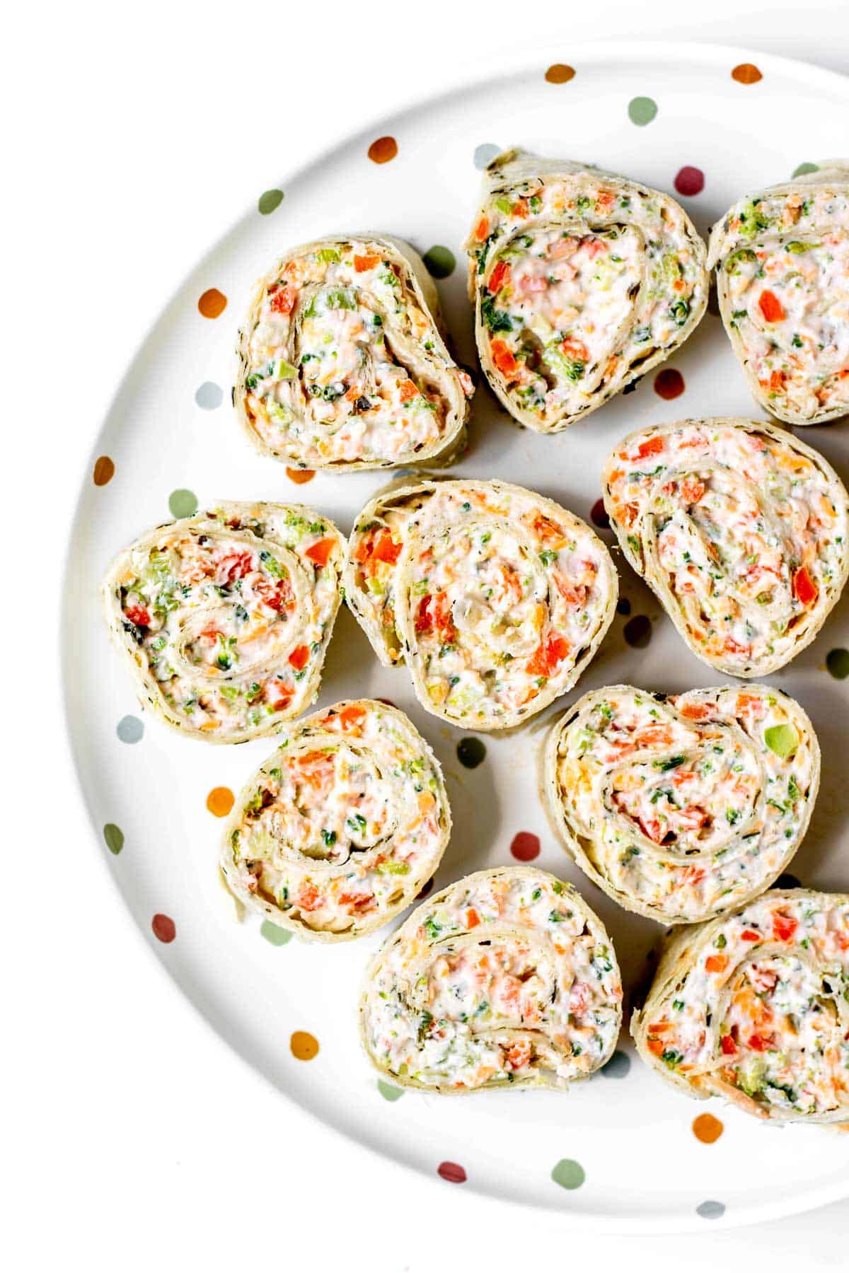 Up close image of broccoli cheese roll ups on a plate.