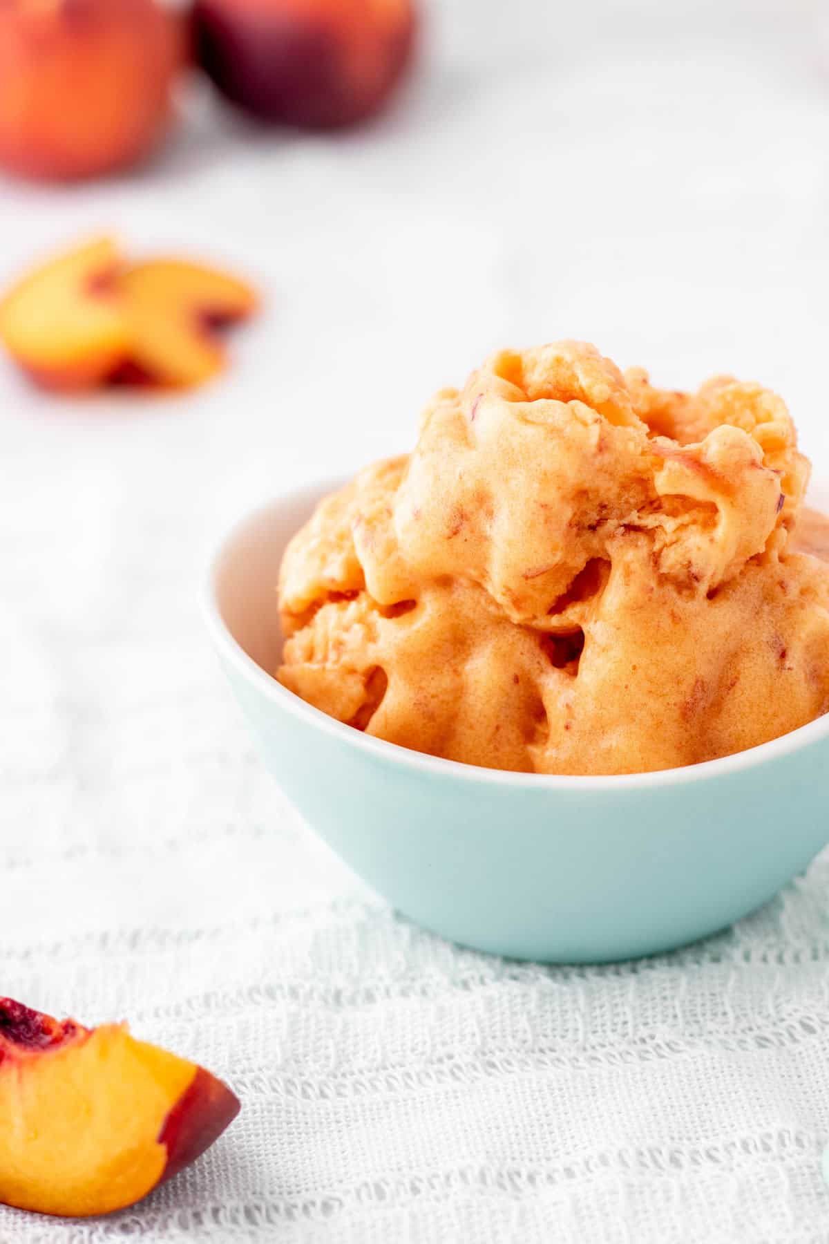 An up close image of 3 ingredient peach sorbet in a small blue bowl.