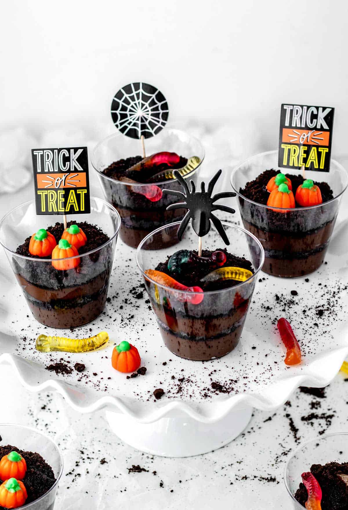 Four Halloween dirt cups on a white tray.