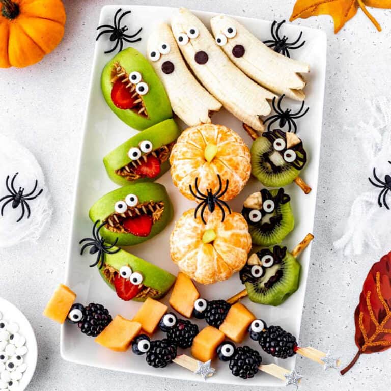 Halloween fruit tray ideas on a white platter.