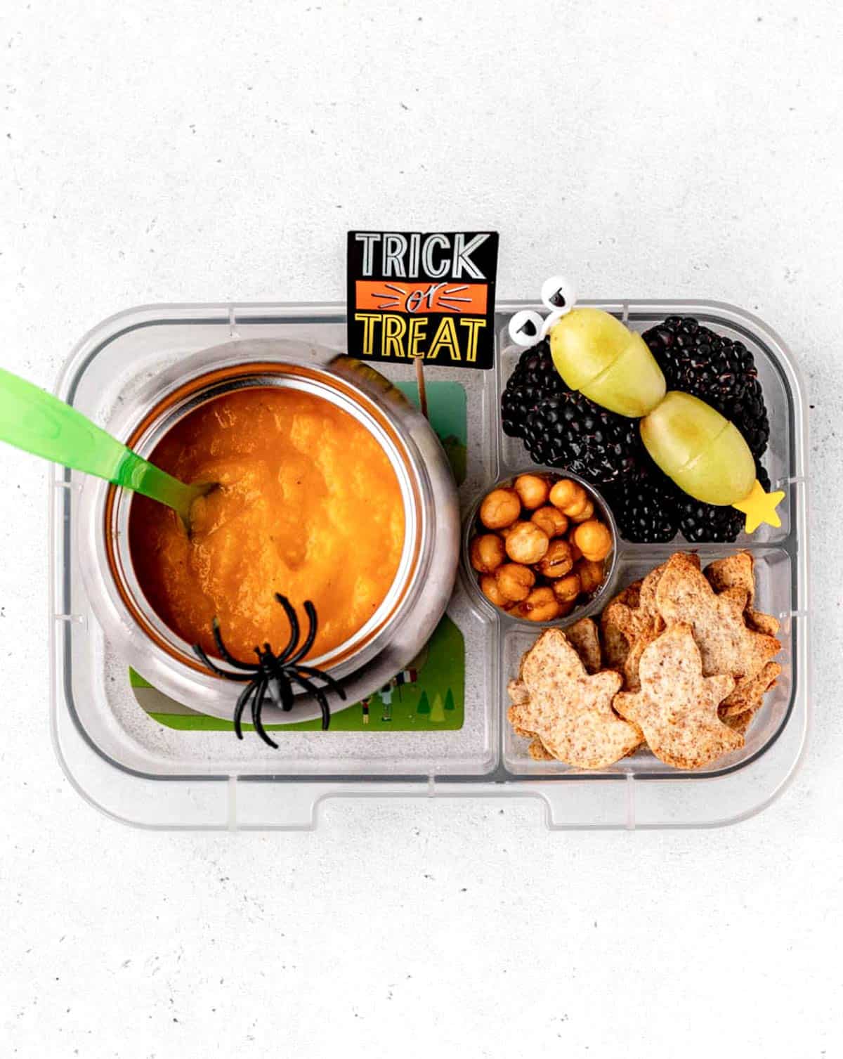 Halloween lunch box with orange sweet potato soup, crispy dried chickpeas, grape monster skewers and tortilla ghosts.