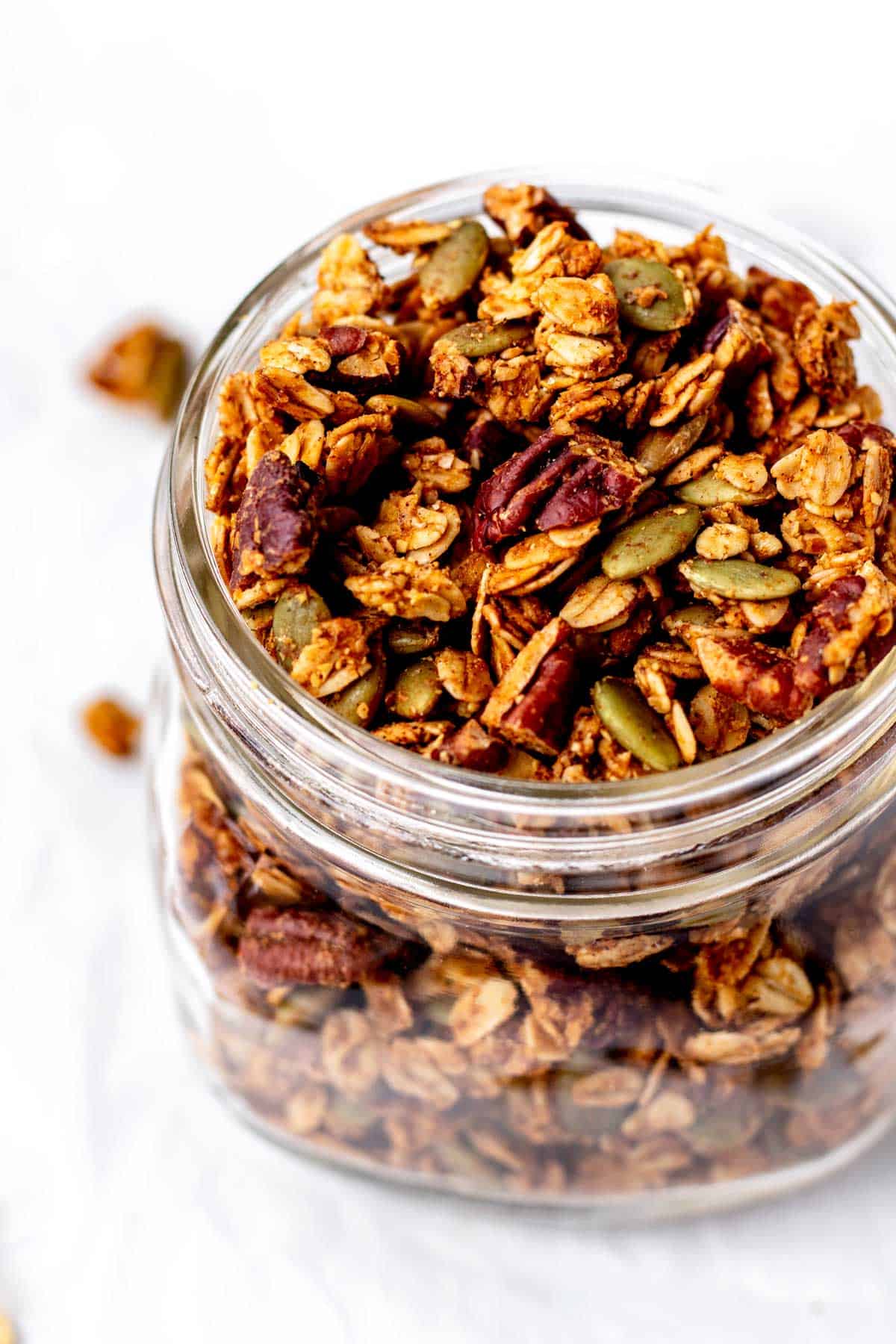 Close up image of pumpkin flax granola recipe in a mason jar.