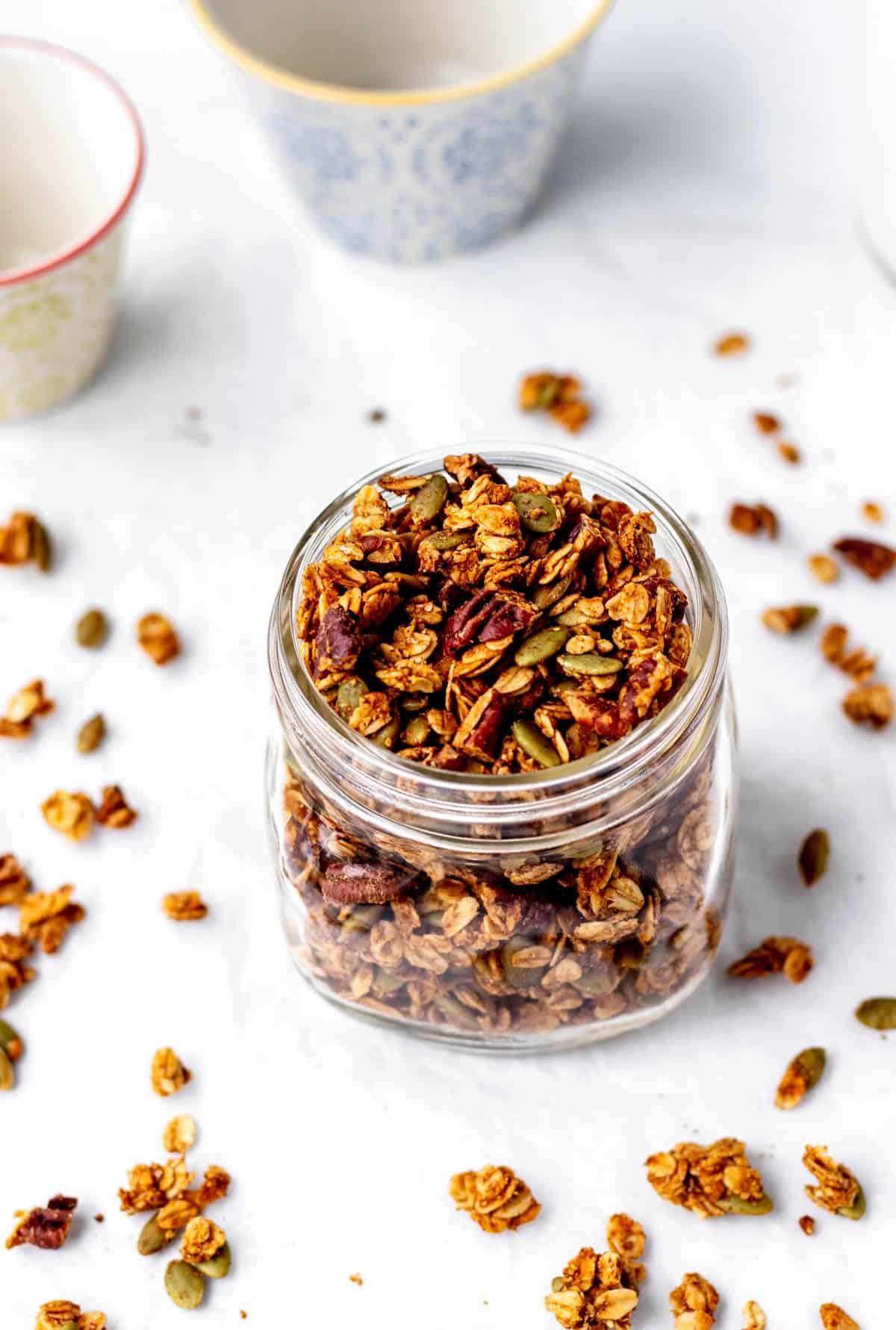 A mason jar filled with pumpkin and flax seed granola.