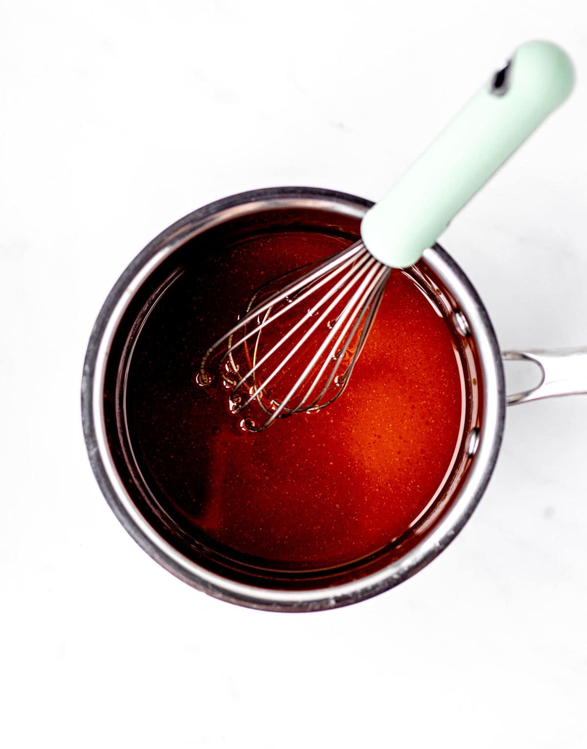 Pumpkin, maple syrup and honey combined in a small saucepan.