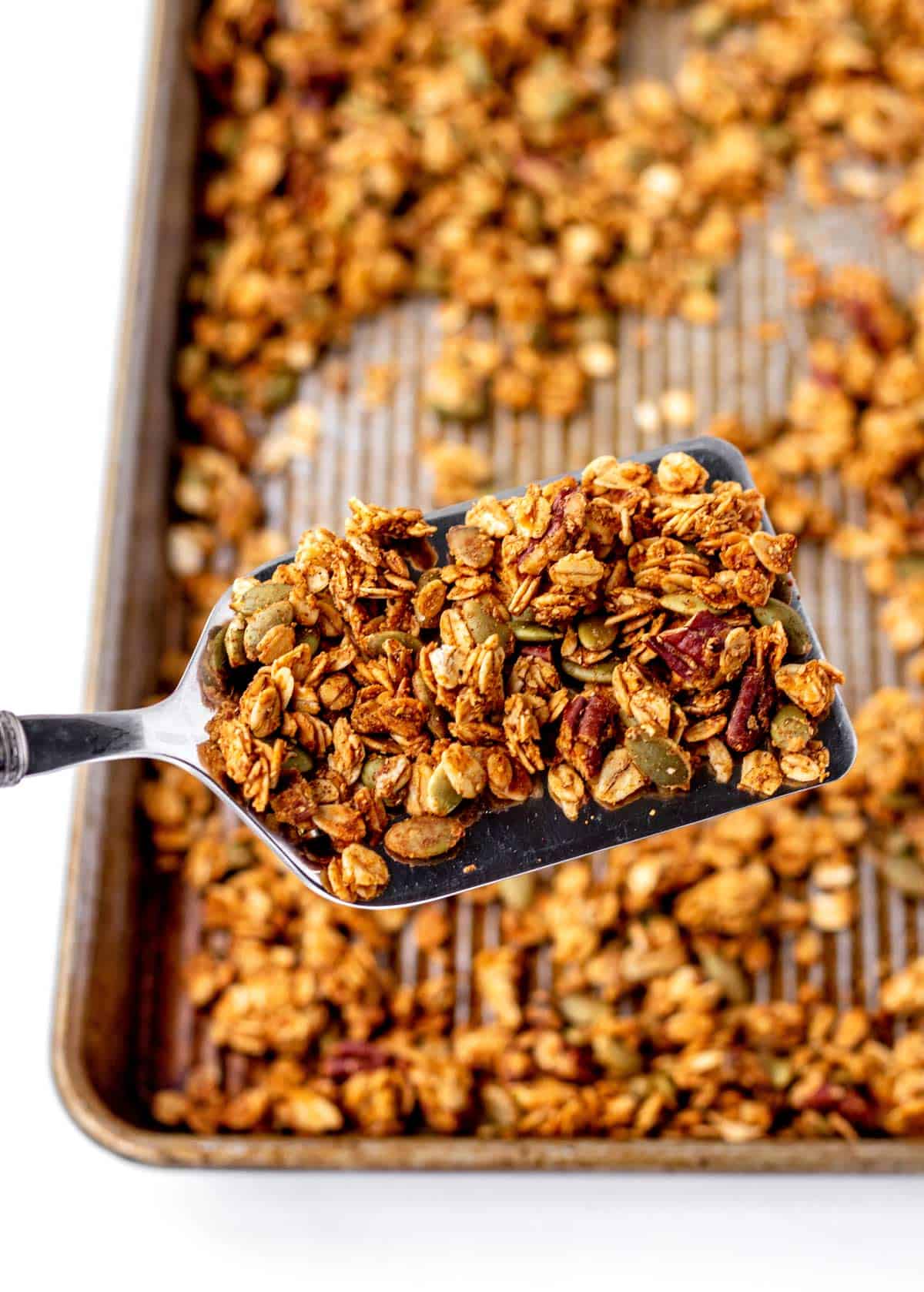 A spatula holding up some pumpkin granola.