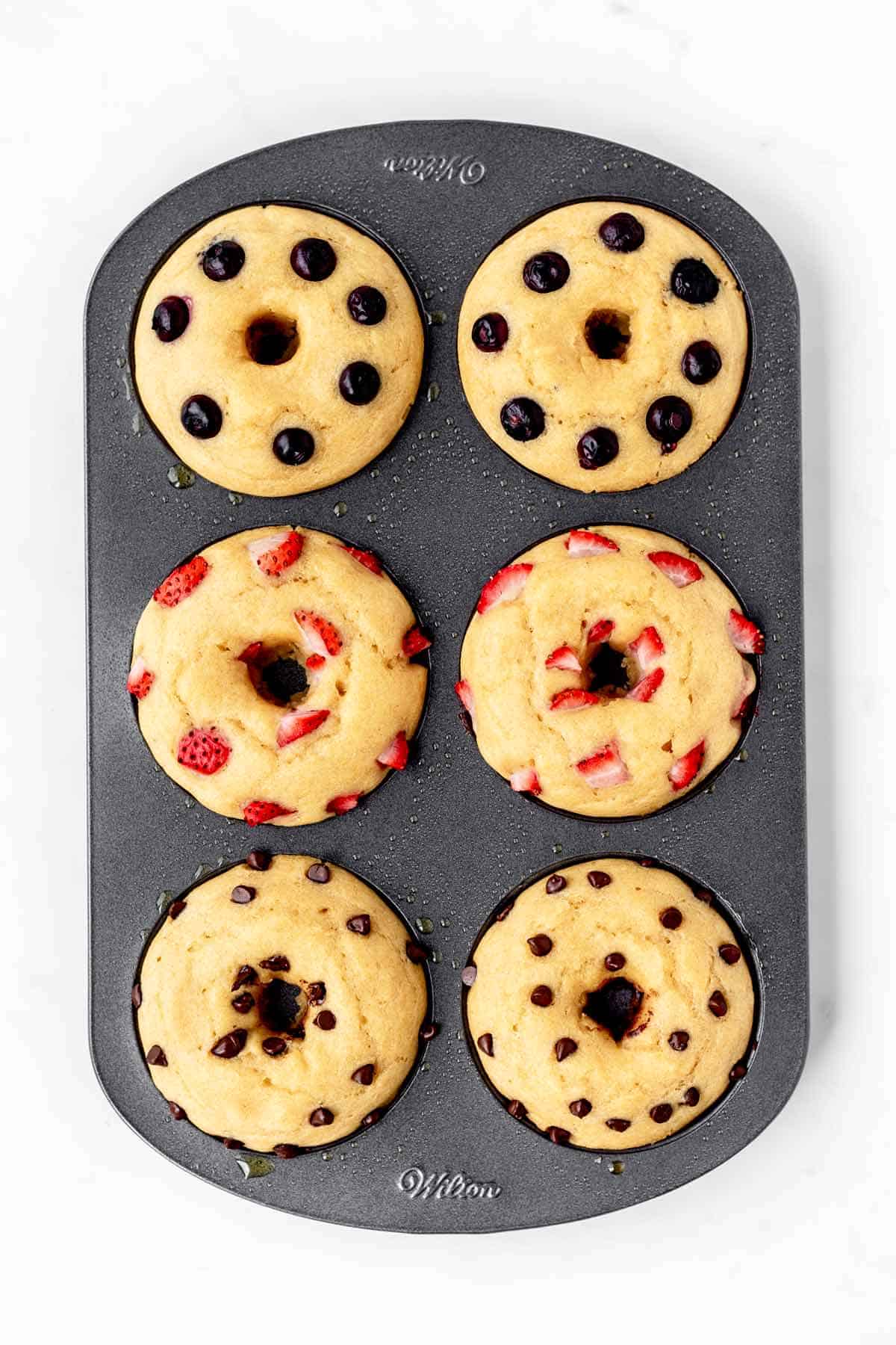 Baked pancake donuts in a donut pan.