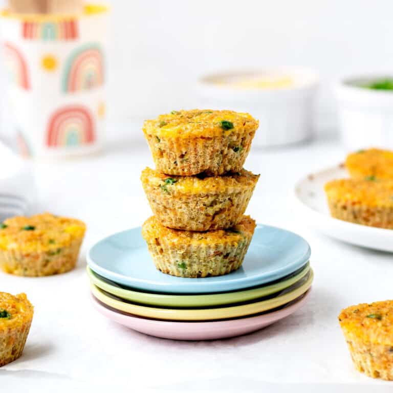 Baked quinoa veggie bites stacked on plates.