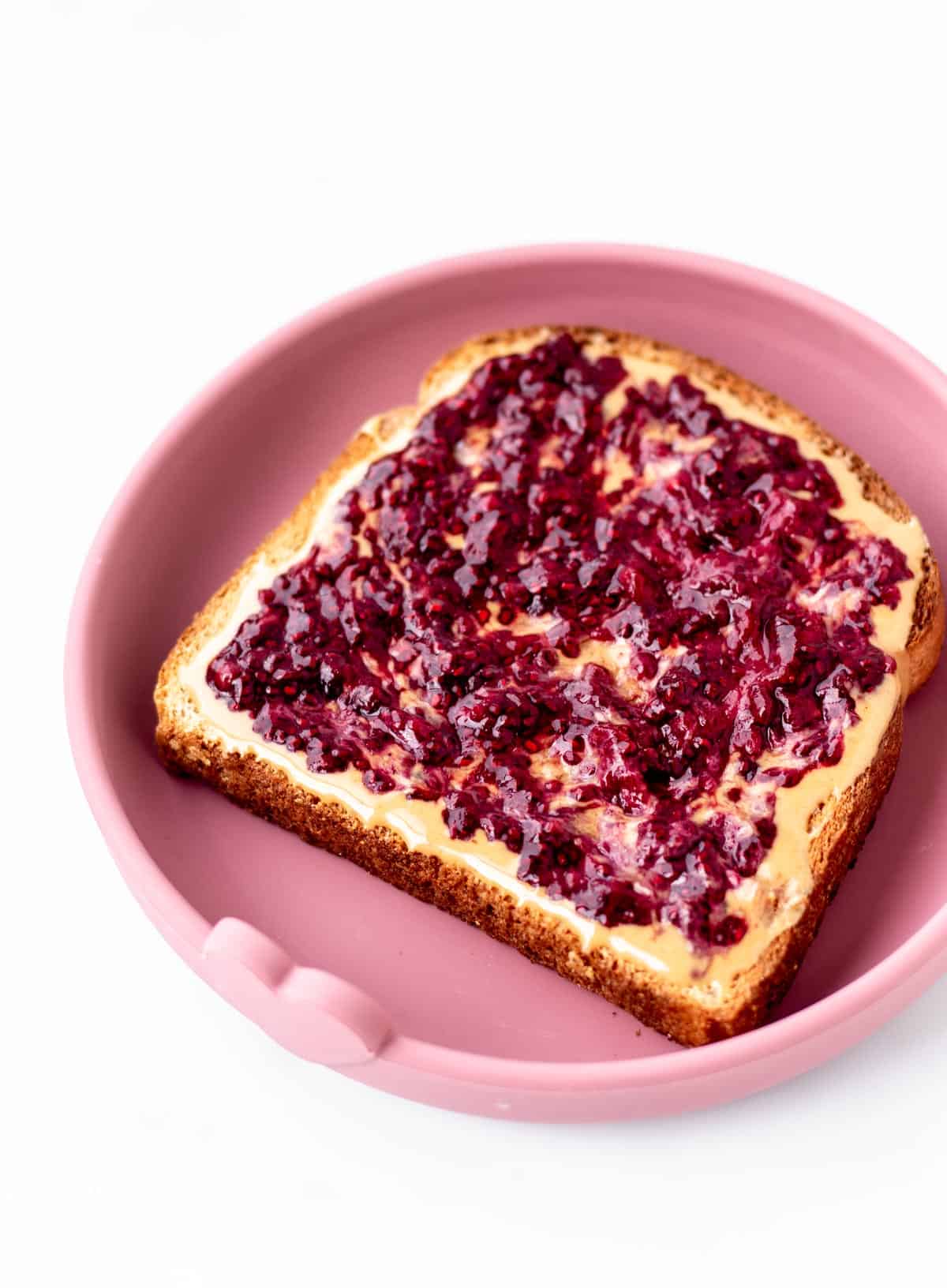 Berry chia jam spread on a piece of toast.