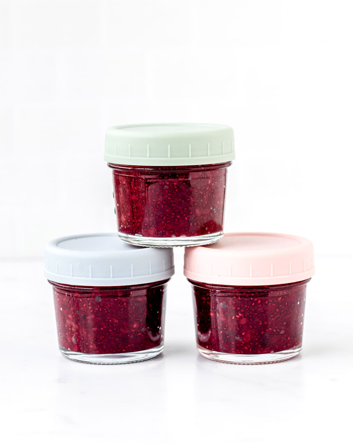 Three jars filled with mixed berry jam for babies.