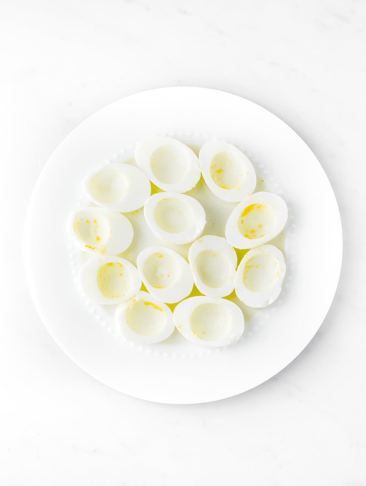 Halved hardboiled eggs with the yolks removed.