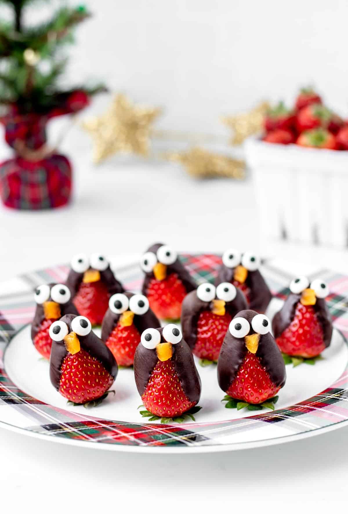 A festive plate filled with penguin strawberries.