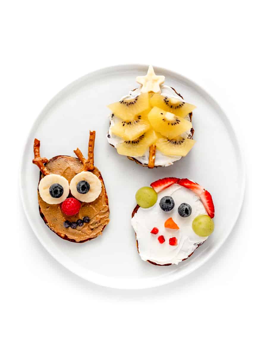 3 decorative bagels featuring a snowman, a reindeer and a Christmas tree.