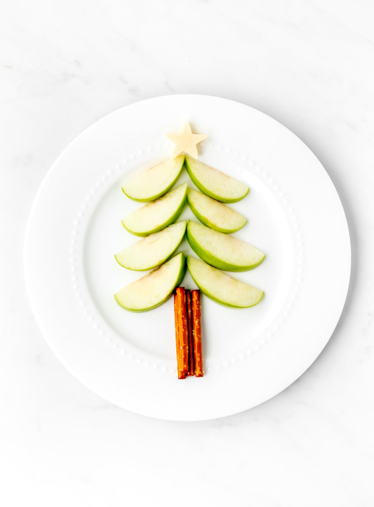 Apple slices and pretzel sticks with a mozzarella cheese star on top.