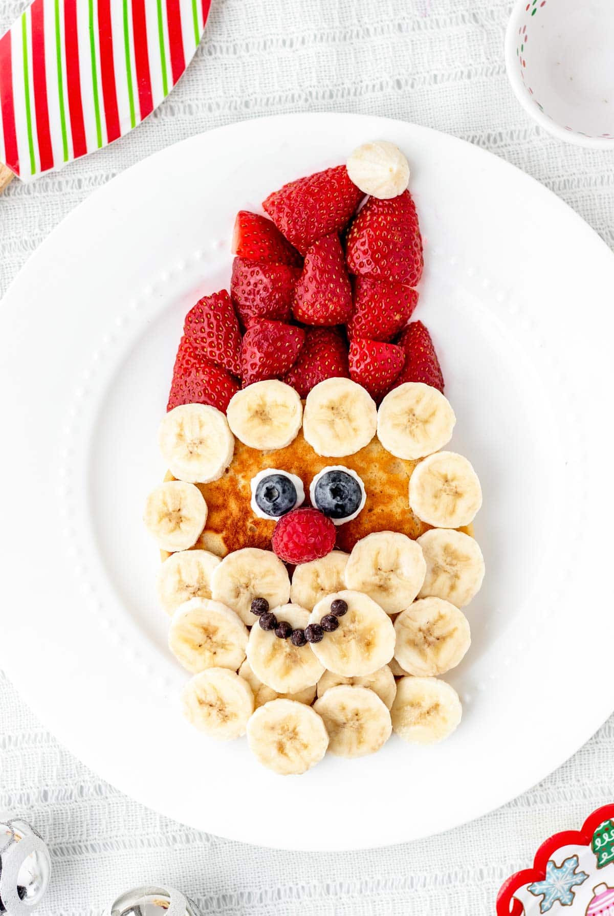 Santa pancake breakfast on a white plate.