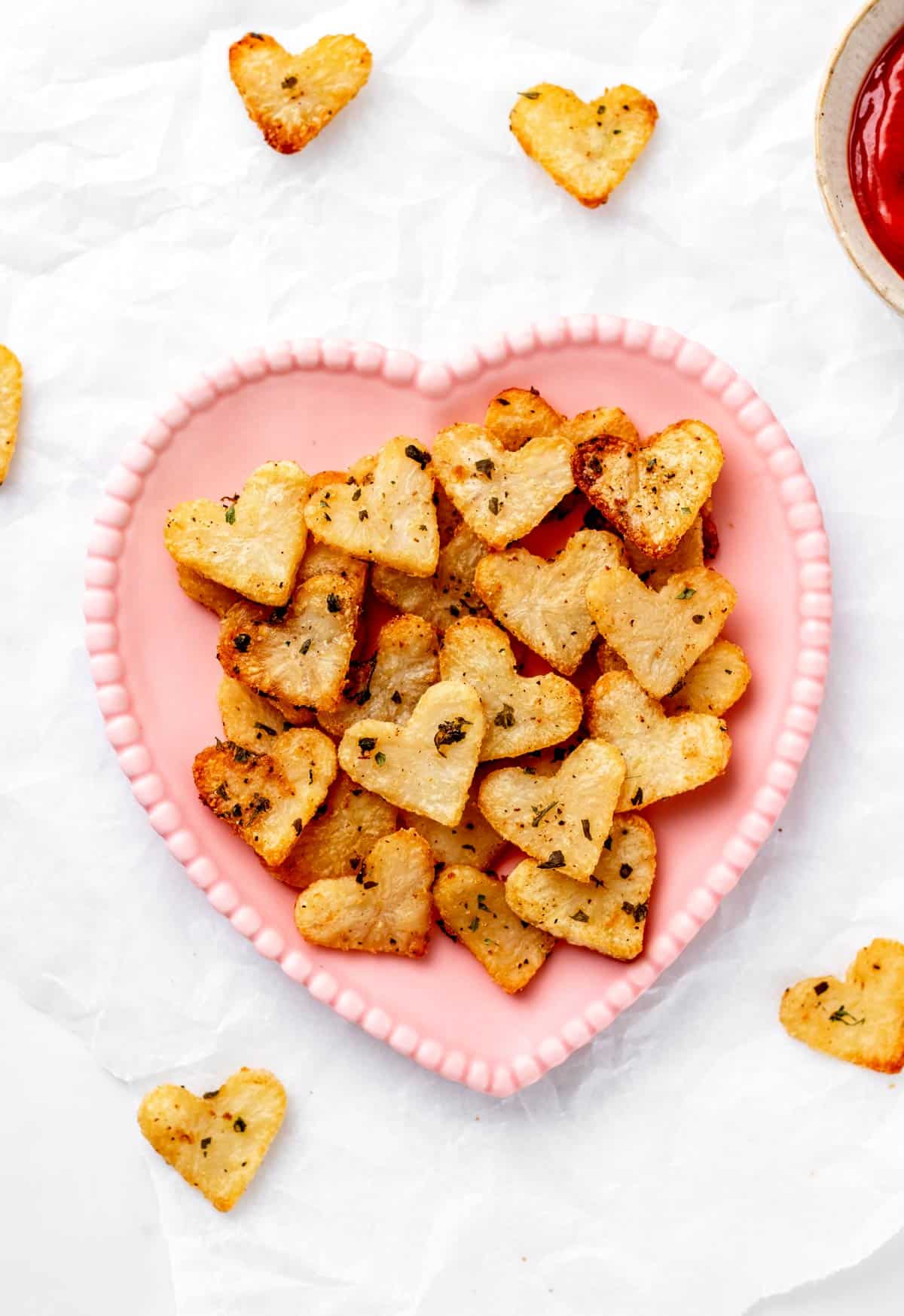 Heart potatoes on a pink heart plate.