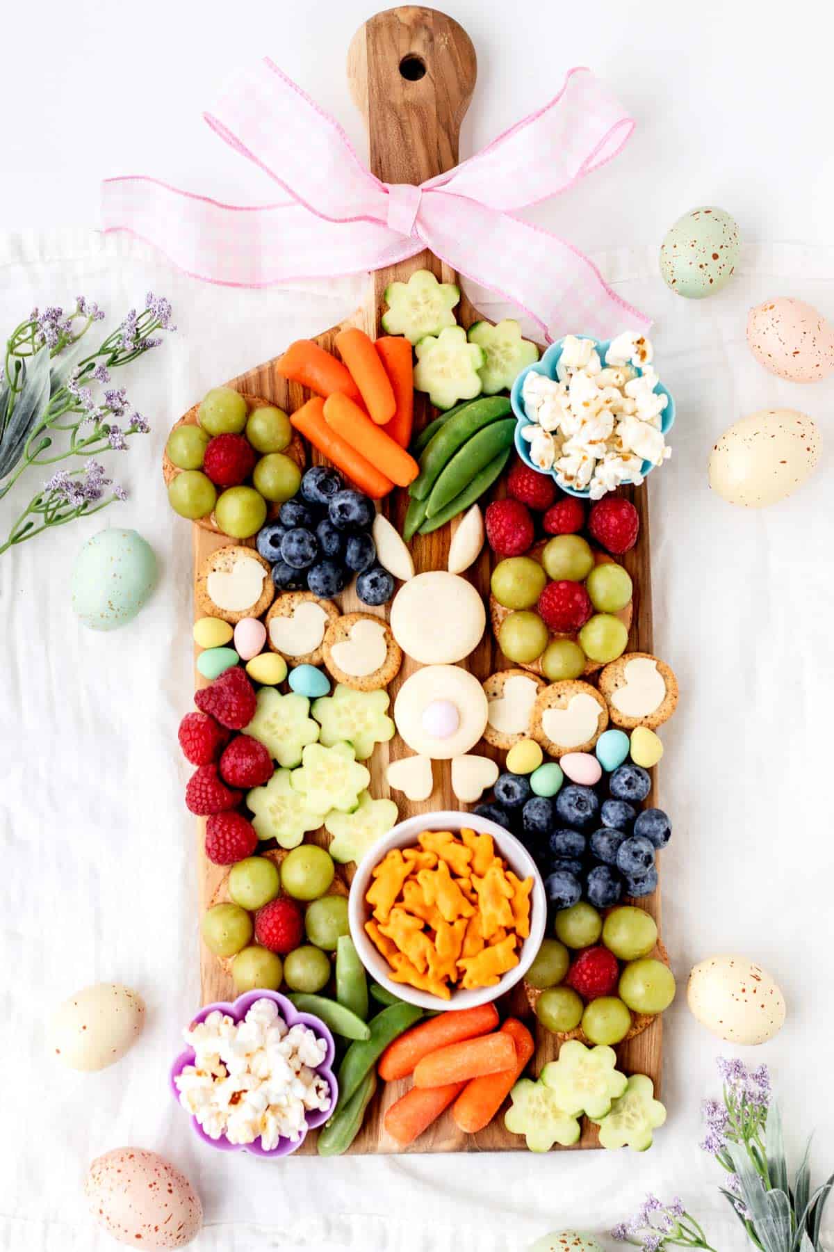 A birds-eye view of 2/3 of an Easter bunny board, with pastel colored eggs on the sides.