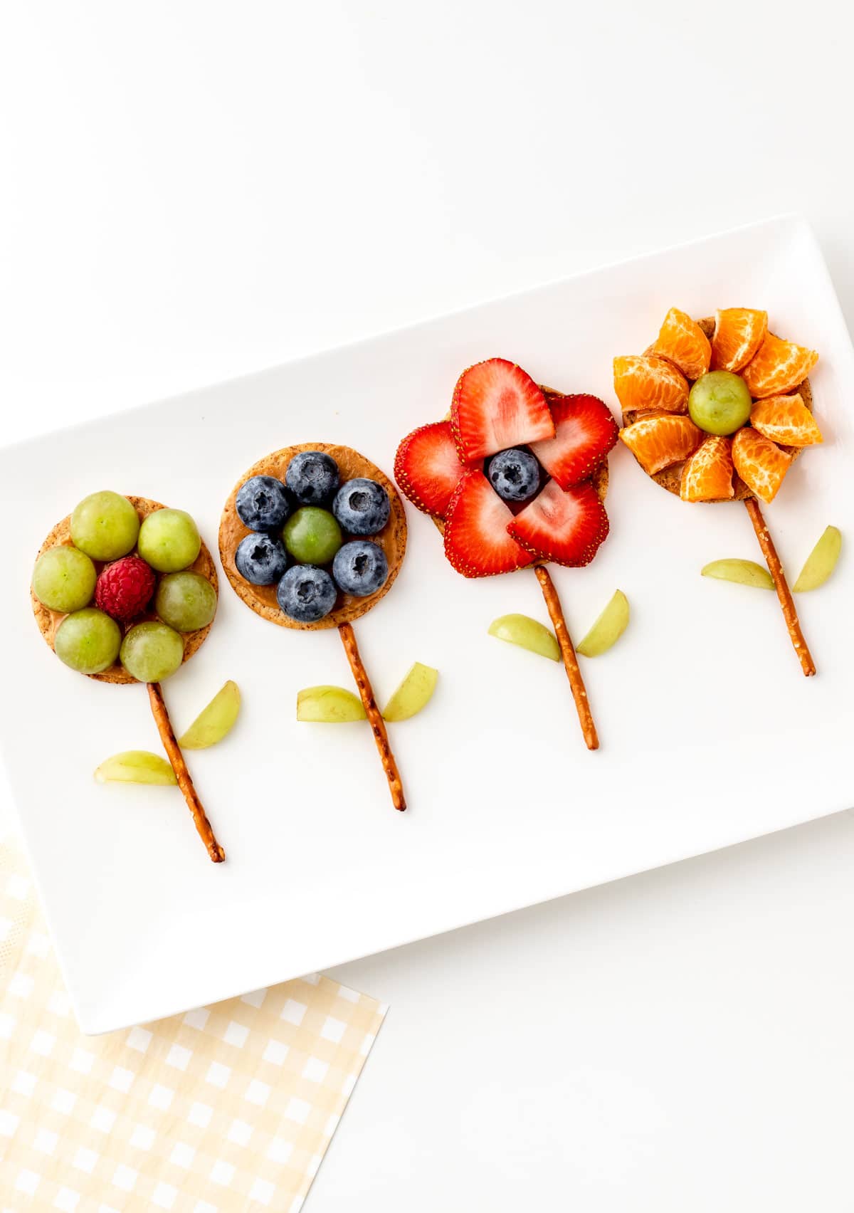 Flower crackers along side one another on a white platter.