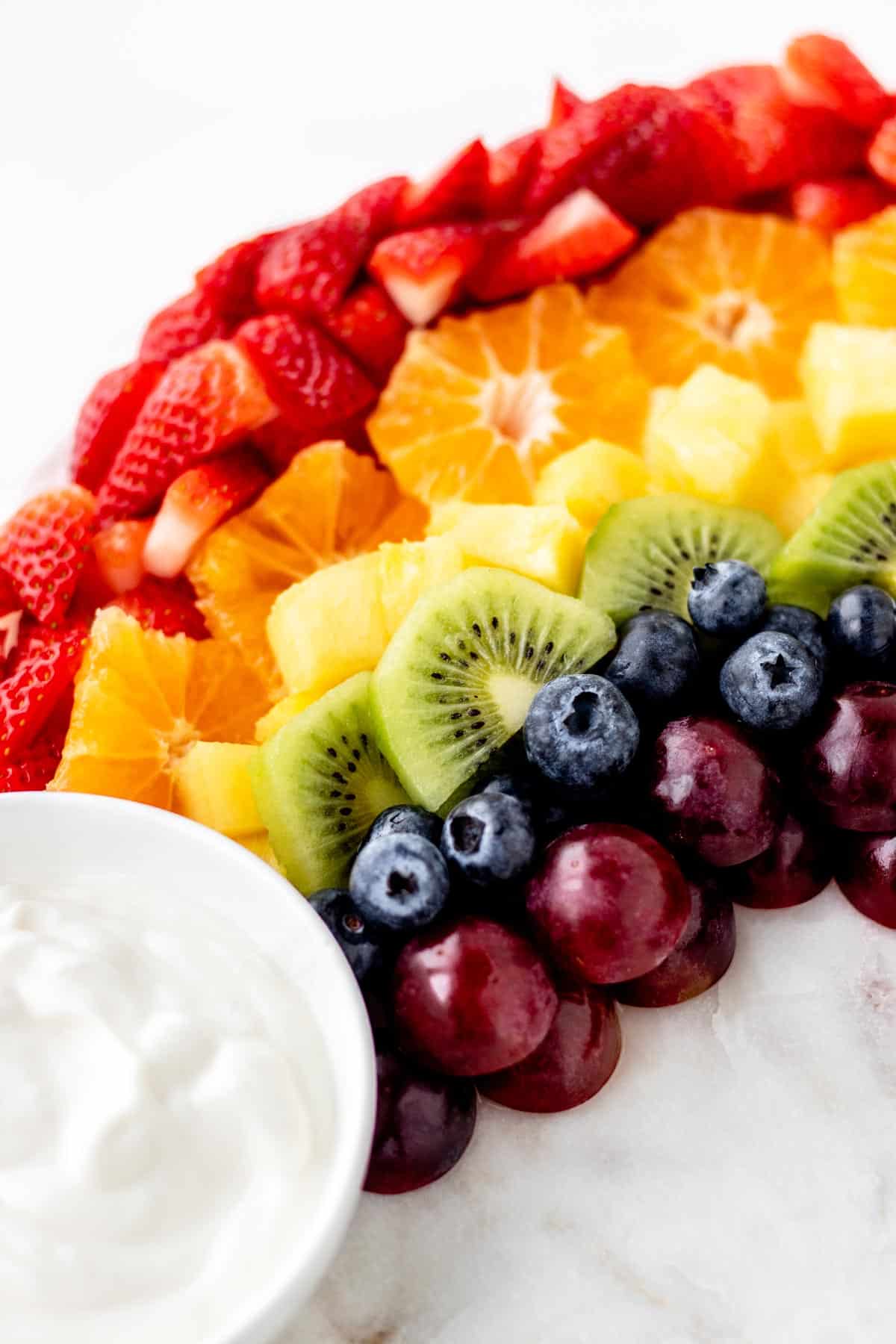 A close-up of a small section of the rainbow fruit board with yogurt dip.