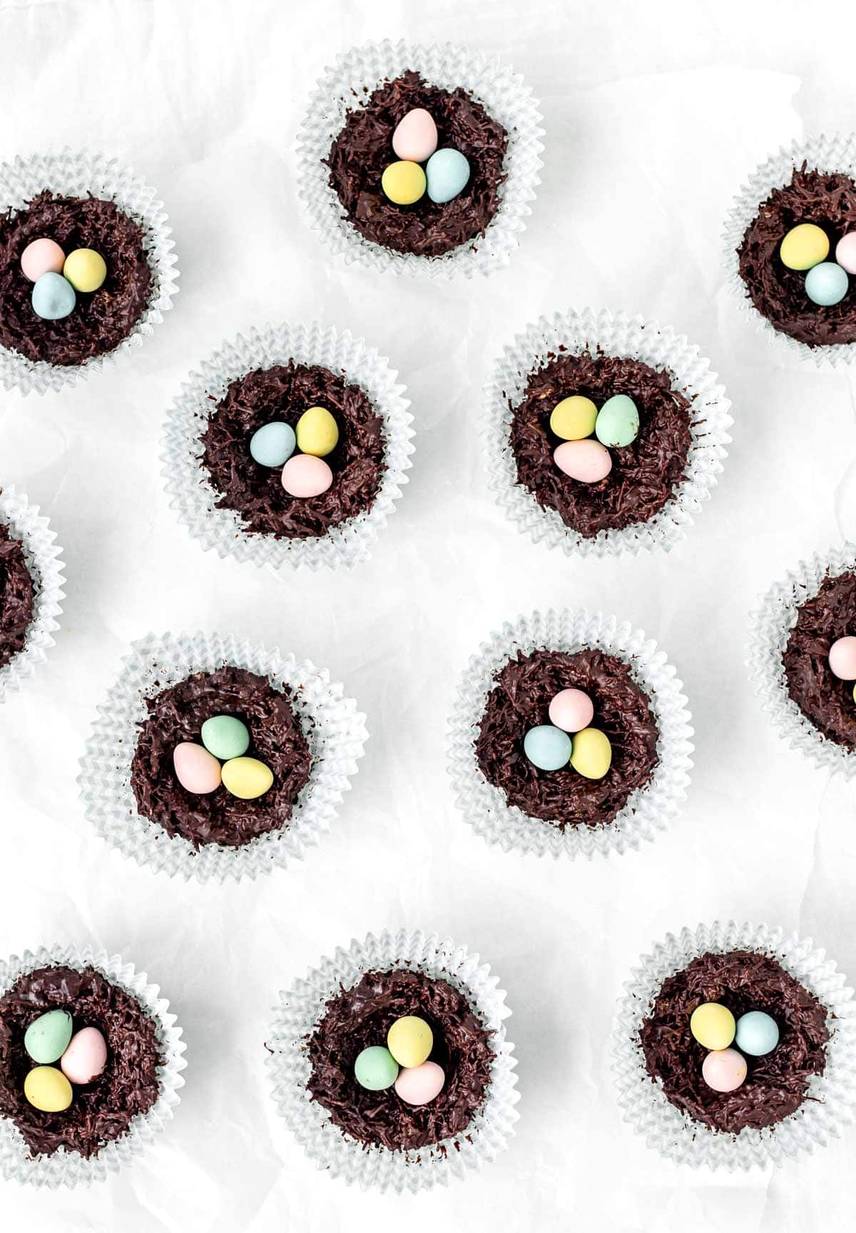 Chocolate Easter nests made out of shredded wheat on a white countertop.