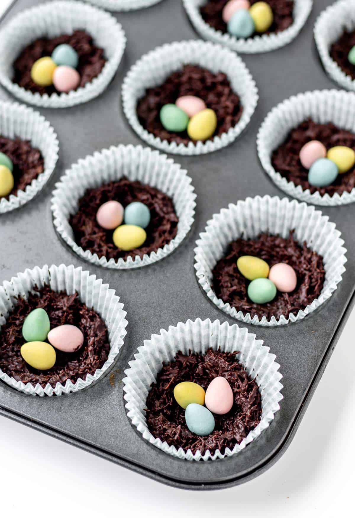 A close-up of a few of the shredded wheat Easter nests in a muffin pan.