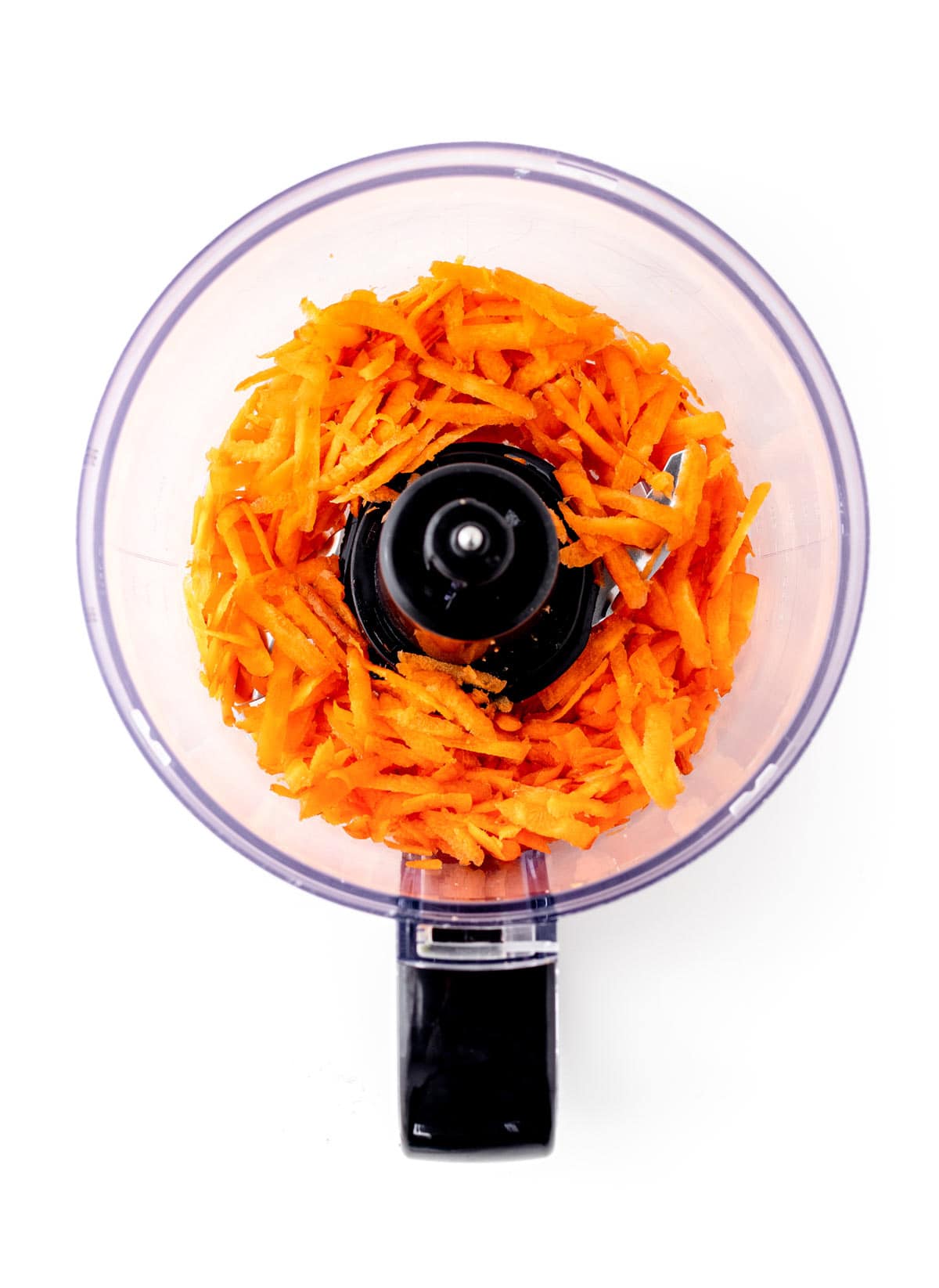 Shredded carrots in a food processor.