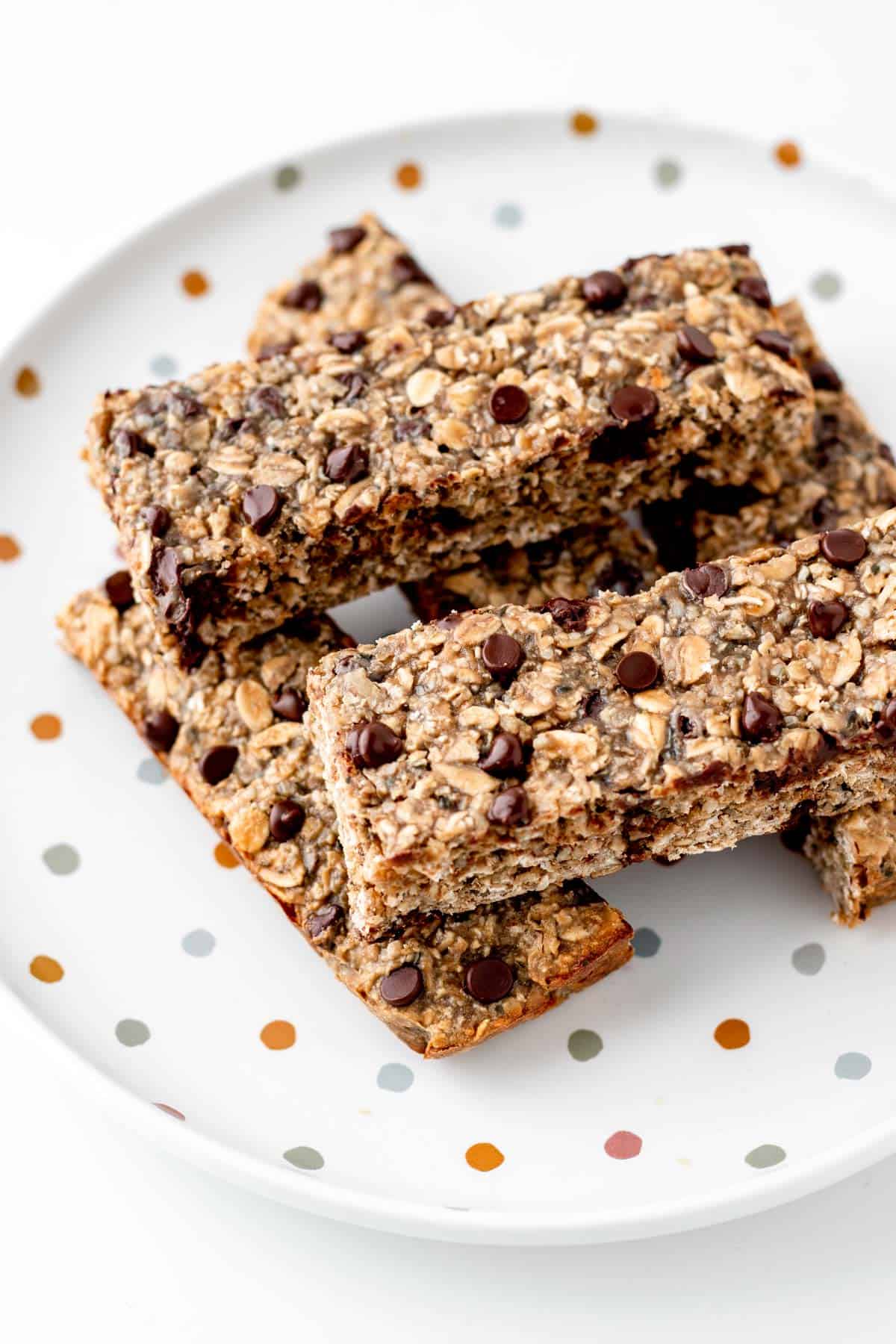 Nut free breakfast bars stacked on top of each other on a polka dot plate.