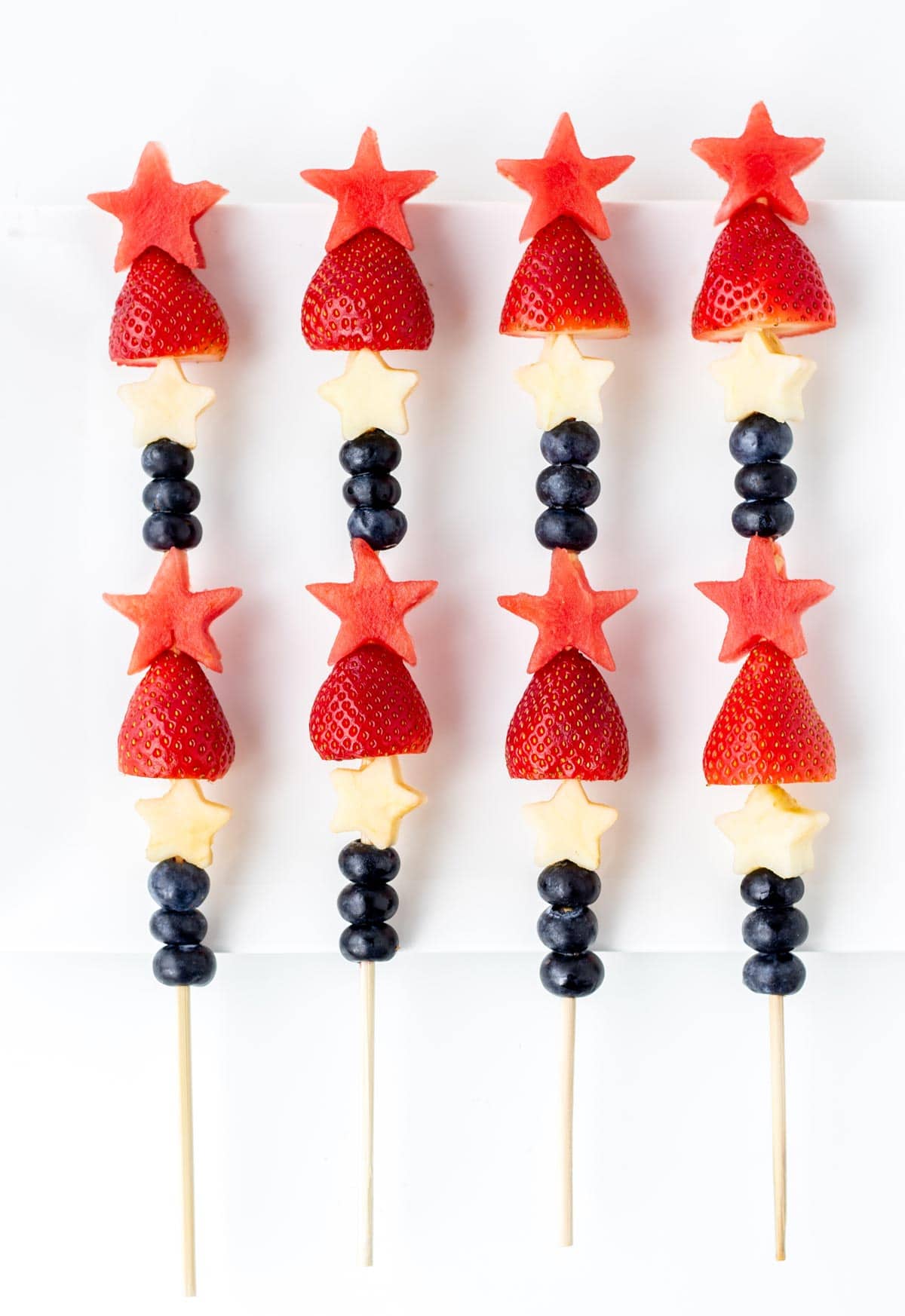 4th of July fruit skewers lined up next to one another.
