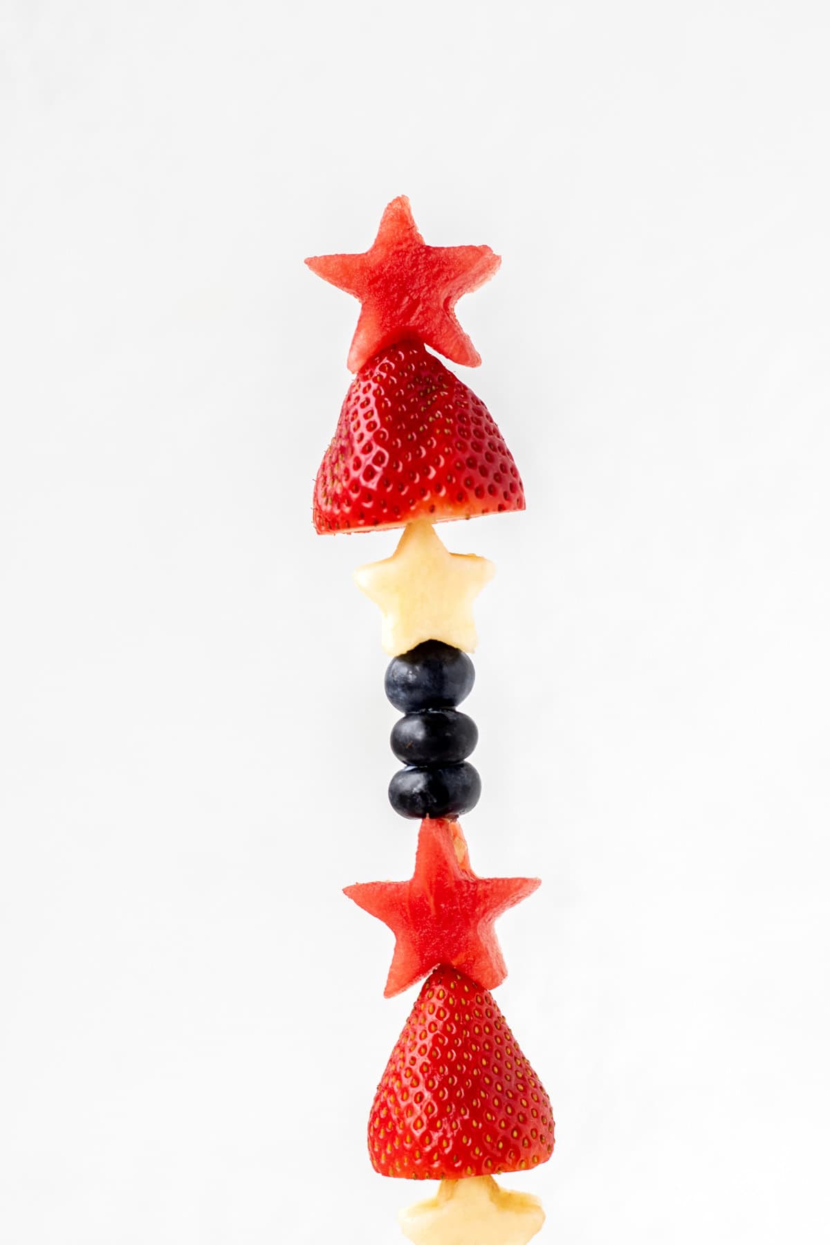 A close-up of a 4th of July fruit skewer.