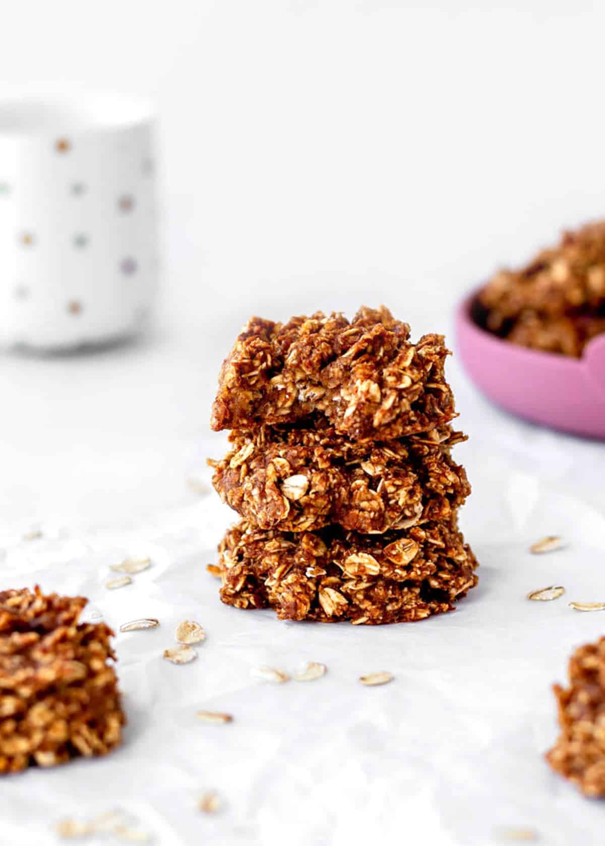 3-ingredient applesauce oatmeal cookies stacked on top of one another on a plate.