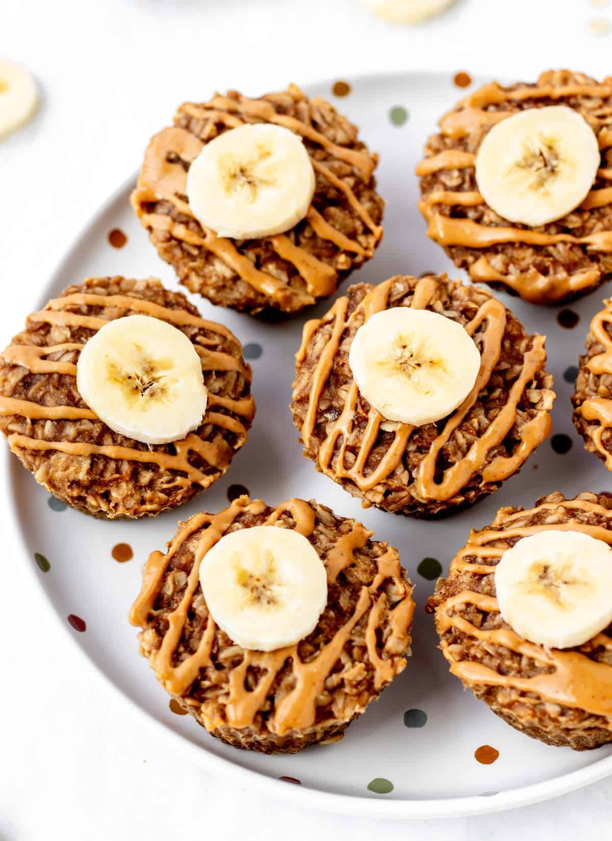 A polka dotted plate full of 3 ingredient banana oat muffins.