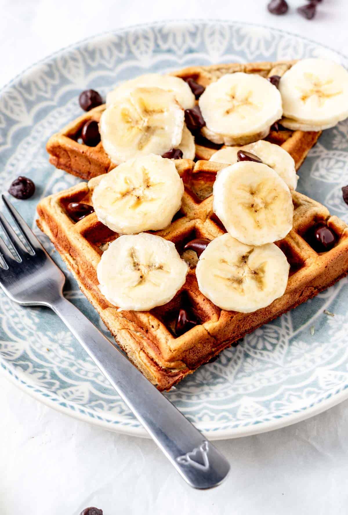 3 ingredient banana oat waffles on a plate with a fork.