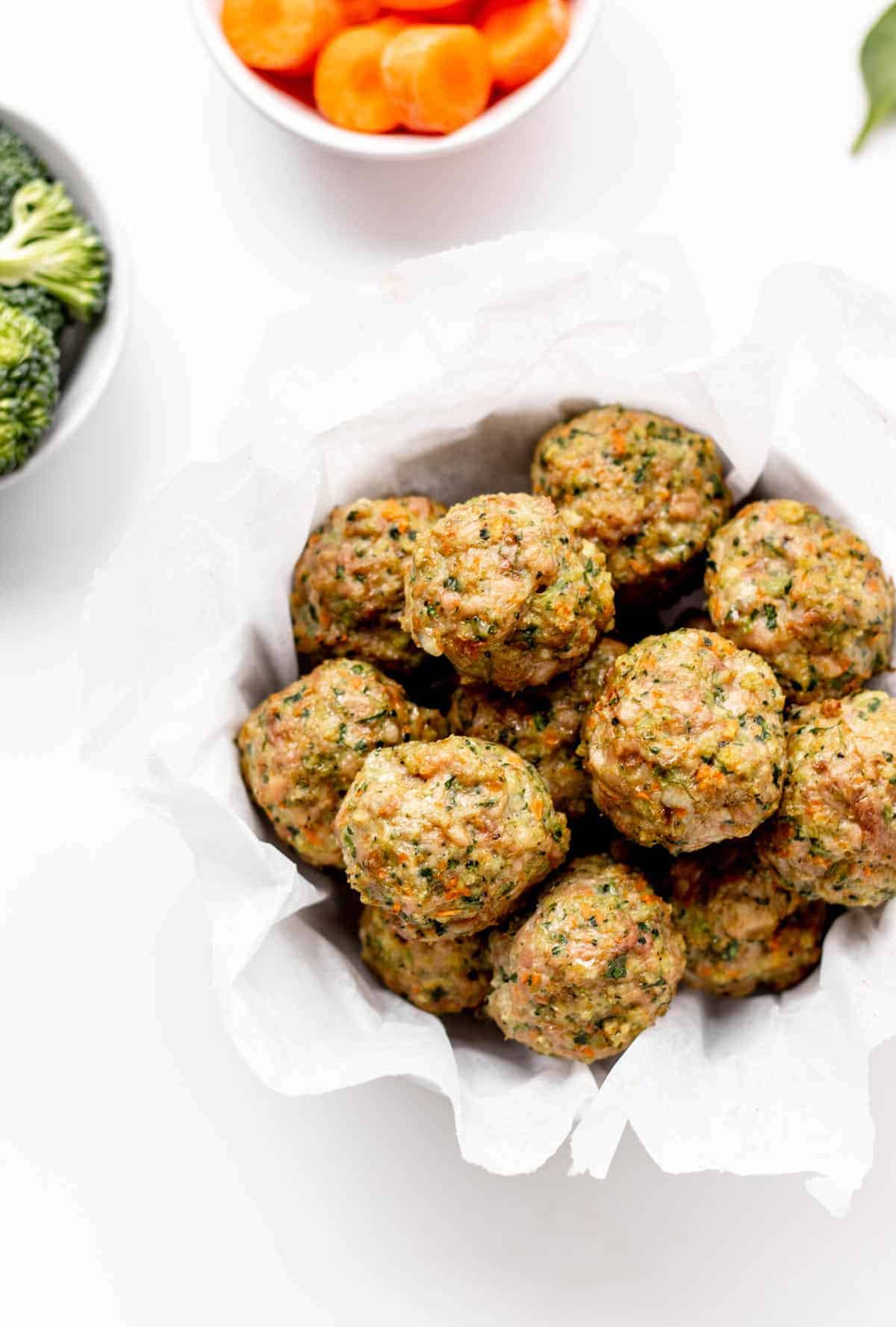 Turkey veggie meatballs in a white bowl on a table.