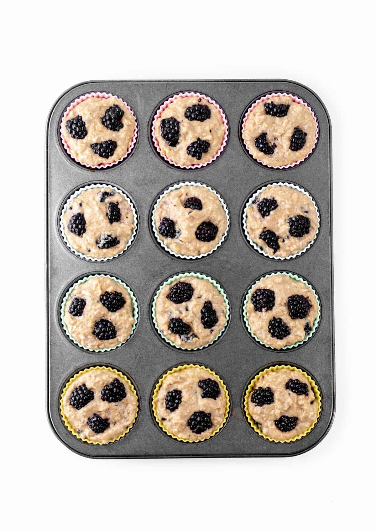 The banana blackberry oatmeal muffin batter poured into a muffin tin prior to baking.